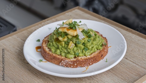 Toast Topped With Avocado Slices and Toppings on a Gray Plate in a Kitchen Se...