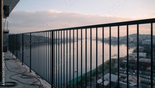 Balcony View of River and City at Dawn With Buildings and Water Reflecting Su...