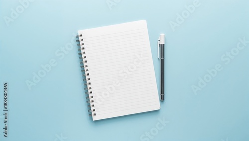 Blank Notebook and Pen on a Light Blue Background Ready for Writing or Drawin...
