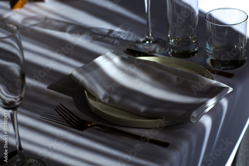 Beautiful table setting with dishes,in a restaurant,light-shadow pattern and style
