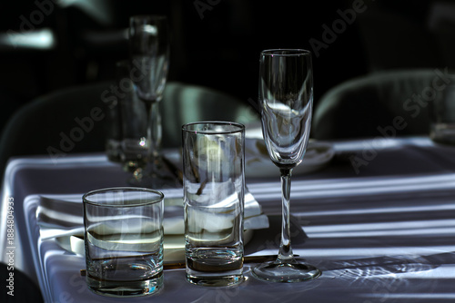 Beautiful table setting with dishes,in a restaurant,light-shadow pattern and style