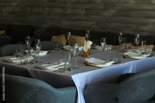 Beautiful table setting with dishes,in a restaurant,light-shadow pattern and style