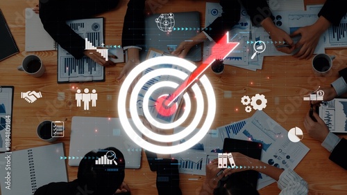 Fotografia A collaborative business meeting scene showcasing diverse hands working together towards a common goal with visual data and target-focused imagery to enhance strategy