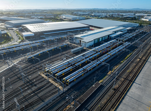 Aerial view of Auckland Wiri Train Depot in New Zealand. Trains are parked for maintenance and storage. The depot supports Auckland's public transportation.