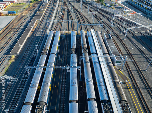 Aerial view of commuter trains parked at a train yard in New Zealand. The trains are awaiting their next scheduled departure for transporting passengers.