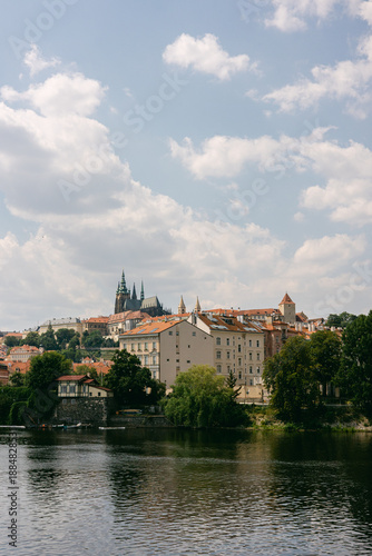 Photography View of Prague with river Vltava and buildings under a cloudy sky in summer