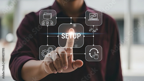 A person touches 'SETUP' on a digital interface with icons for folders, laptop, refresh symbol, and gears, representing the process of configuring and preparing a system or project.