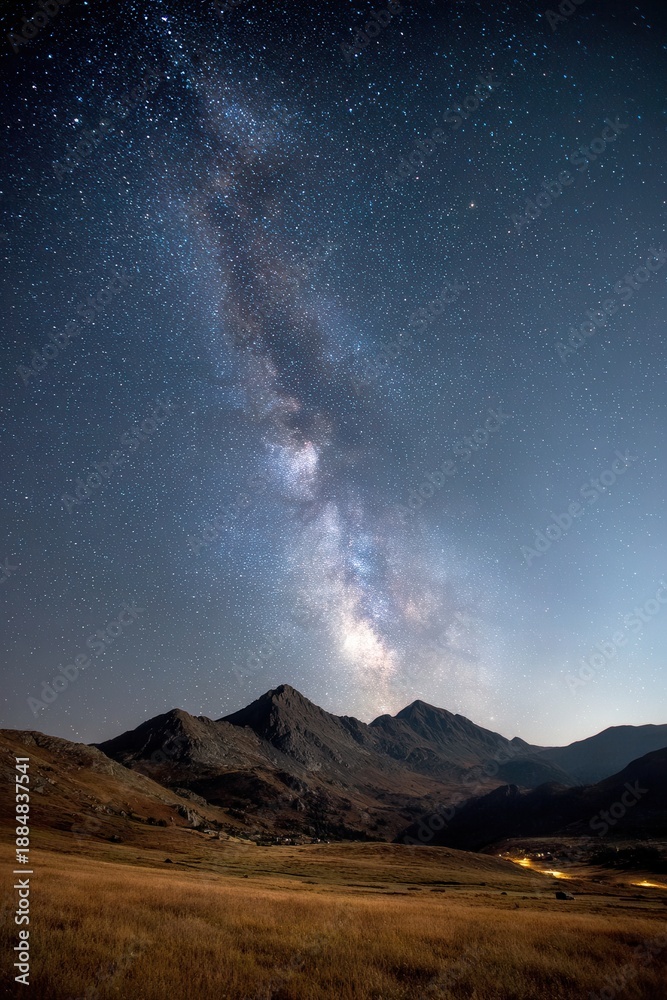 Fototapeta premium Milky Way arching over mountain range