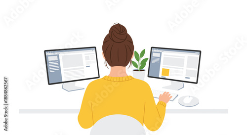 A woman seen from behind works on a computer with two monitors, sitting at a desk with a plant, suggesting remote work or office environment.