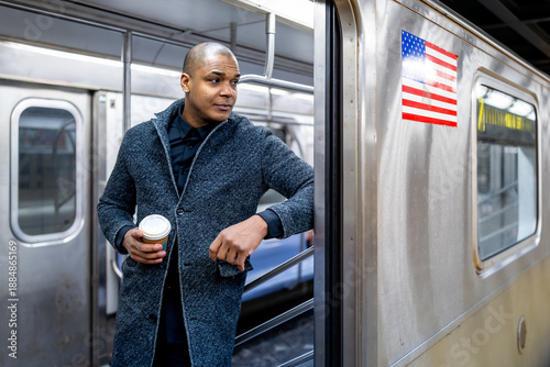 Man commuting subway in new york city with coffee cup