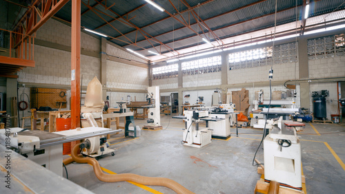 Tableau sur toile Spacious woodworking workshop with various industrial machinery and tools for pr