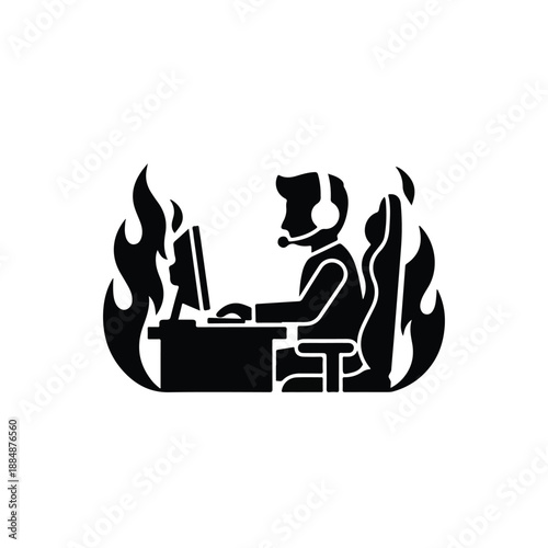 Person working intensely on computer surrounded by flames viewed from the side