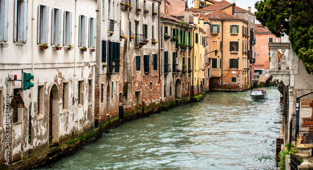 Naklejka premium Boat Is Floating Down Old Canal