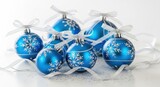 Elegant Blue Christmas Ornaments with Snowflake Designs and White Ribbons.