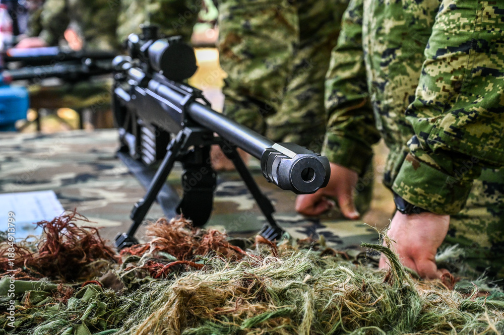 Fototapeta premium Long range sniper rifle. High-precision sniper in front of the soldiers in uniform. 
