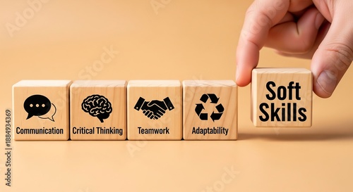 Wooden blocks with icons representing soft skills like communication, critical thinking, teamwork, and adaptability, with a hand placing the 'Soft Skills' block.
