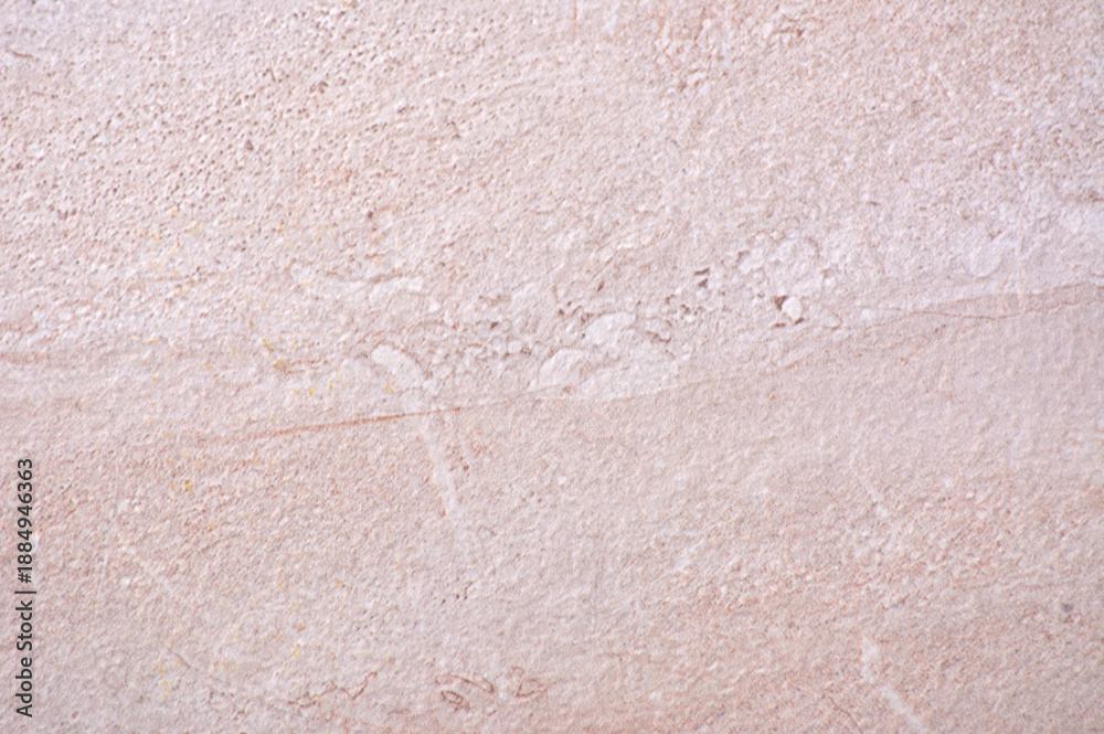 Fototapeta premium Pink marble, a roughly hewn natural stone with a distinctive pattern, close-up.