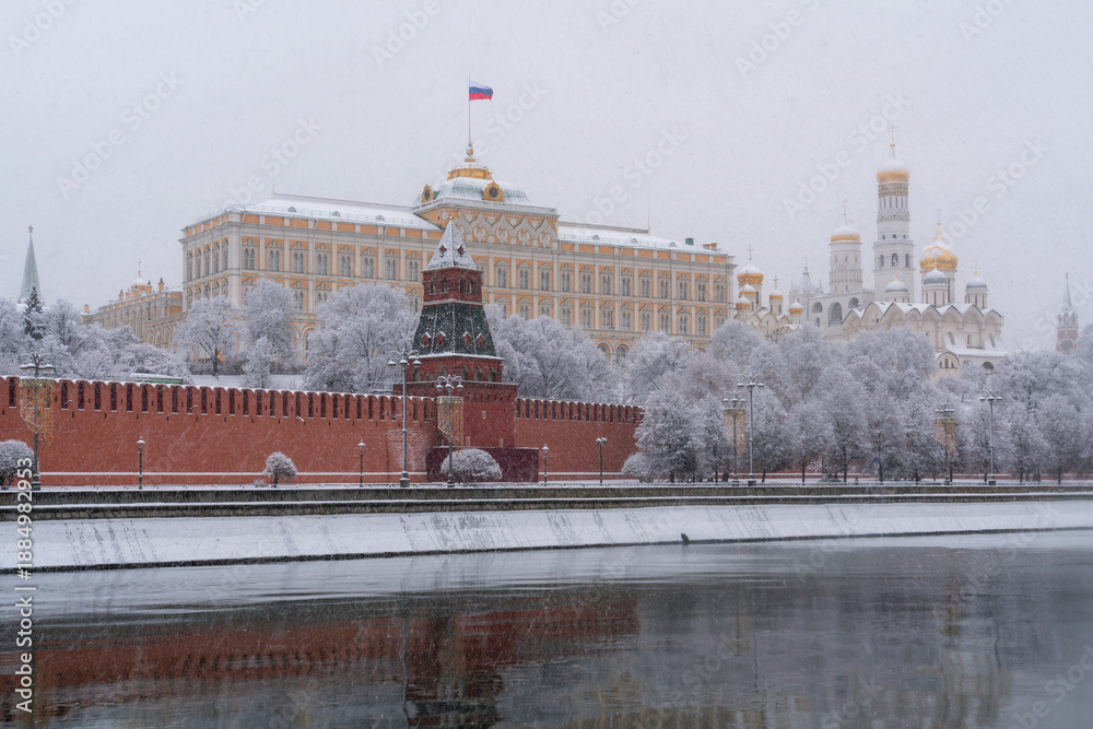 Obraz premium Grand Kremlin Palace, the Annunciation Tower and the ensemble of the Kremlin Cathedral Square from the embankment of the Moskva River in heavy snowfall, Moscow, Russia