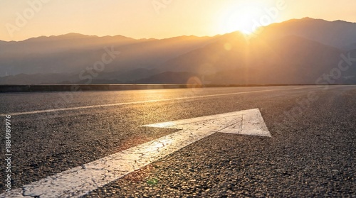 white arrow sign asphalt road with rising sun background