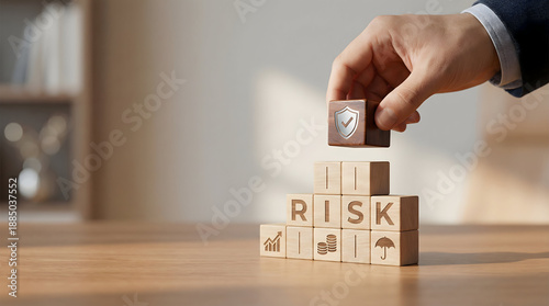 Insurance and risk control concept with hand arranging wooden blocks