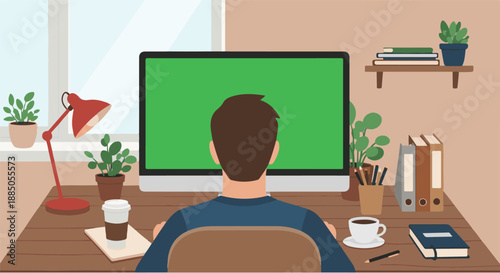 A person works at a desk with a computer screen displaying a green screen, surrounded by office supplies and plants