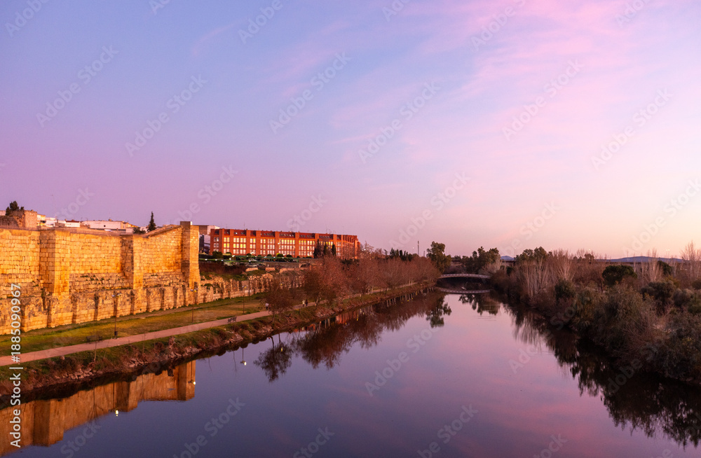 Obraz premium Romantic pink and blue sunset reflected in the Guadiana River in Merida Spain ESP