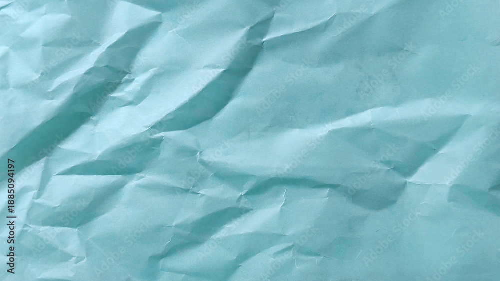 Obraz premium Crumpled light blue paper texture background with abstract folds and creative wrinkles