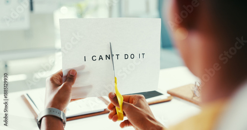 Fotografi Hands, cutting and word for motivation, office and scissors to remove negative letters and document