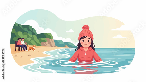 A girl in a hat and jacket wades into the sea, a couple and dog on the beach