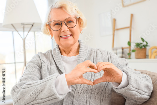 Happy elderly woman showing...