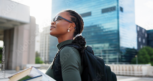 Photos Black woman, student and happy in city, thinking and travel with glasses, backpack and books for learning
