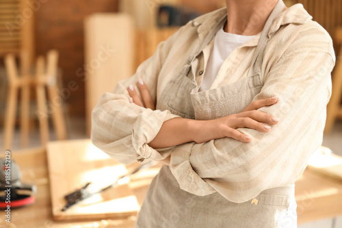 Young female carpenter with...