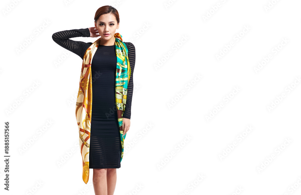 Fototapeta premium Asian girl wearing a silk scarf on a white background
