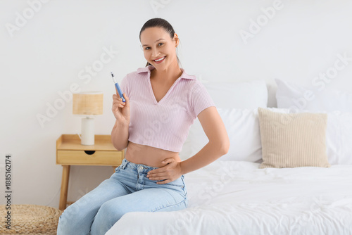 Young woman with syringe of...