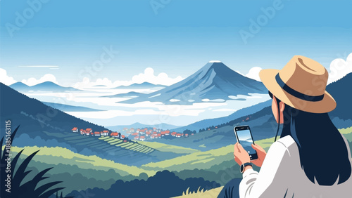 A person in a hat captures a scenic village and distant mountain with a smartphone