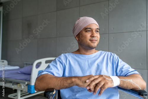 Принти на полотні A male cancer patient in a wheelchair with an IV smiles with joy and hope showing strength and positivity during treatment