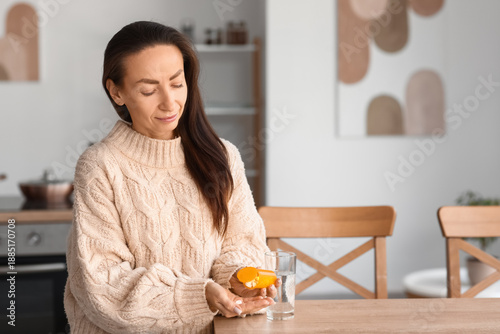 Beautiful woman taking medi...