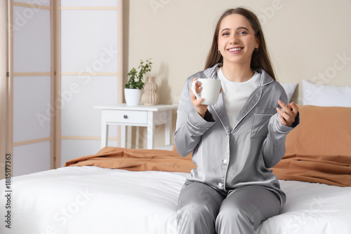 Pretty young woman with cup...