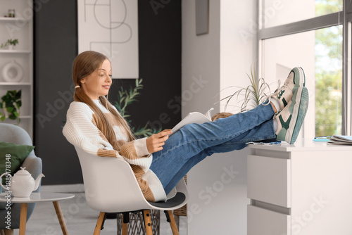 Young woman reading magazin...