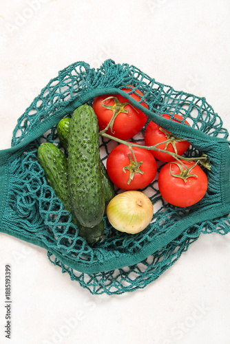 Mesh bag with fresh cucumbe...