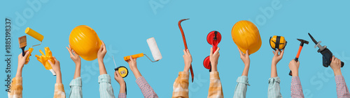 Many hands with hardhats an...
