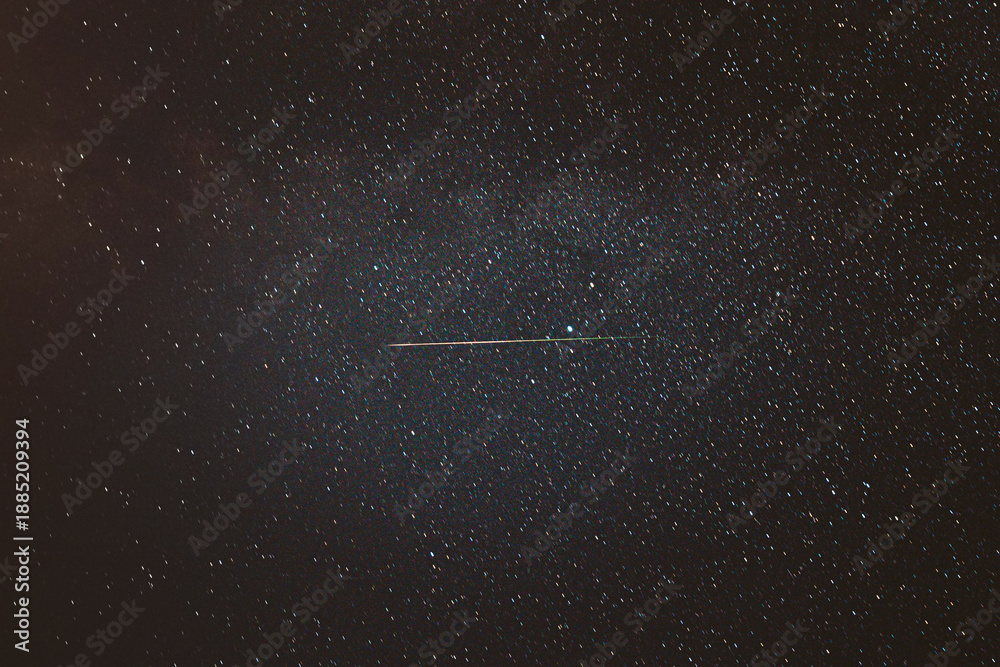 Fototapeta premium Real Night Sky Stars With Milky Way Galaxy. Natural Starry Sky Background with meteor trails lights. Background Night Starry Sky With Bright Stars And Meteoric Track Trail