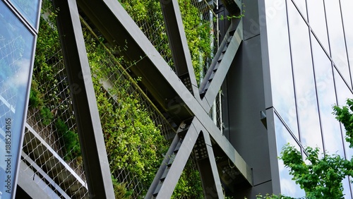 Closeup of exposed steel structure X-brace green wall screen element on a high-rise