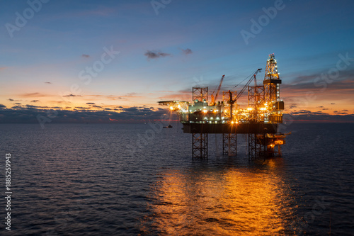 Aerial view of offshore jack up rig in a shipyard during sunset for oil and gas exploration and production.