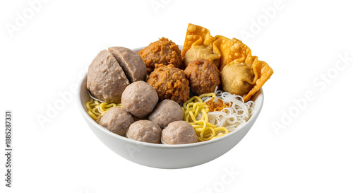 Bowl of Indonesian meatballs sits isolated with noodles and fried wontons.
