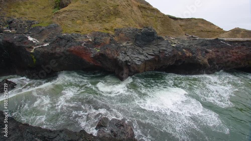Footage capturing powerful ocean waves churning and crashing into the narrow chasm of Devil's Churn in the Cape Perpetua Scenic Area near Yachats, Oregon.