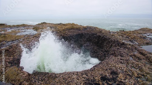 Footage of Thor's Well, a bowl-shaped hole carved into the basalt shoreline near the Cape Perpetua Scenic Area on the rocky coast of Oregon.
