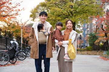 Family enjoying autumn day together outdoors in Tokyo park