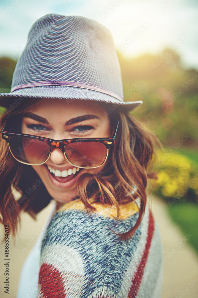 Fototapeta premium Portrait, woman and smile with sunglasses outdoor for travel, spring adventure and holiday trip. Happy, female person and explore nature with eyewear, sunshine and vacation getaway in countryside