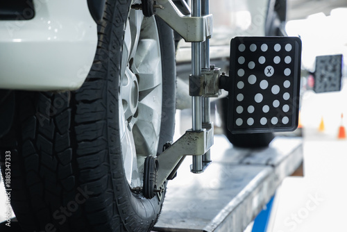 Konstfotografi Close-up of 3D wheel alignment target sensor clamped to car alloy wheel for stee